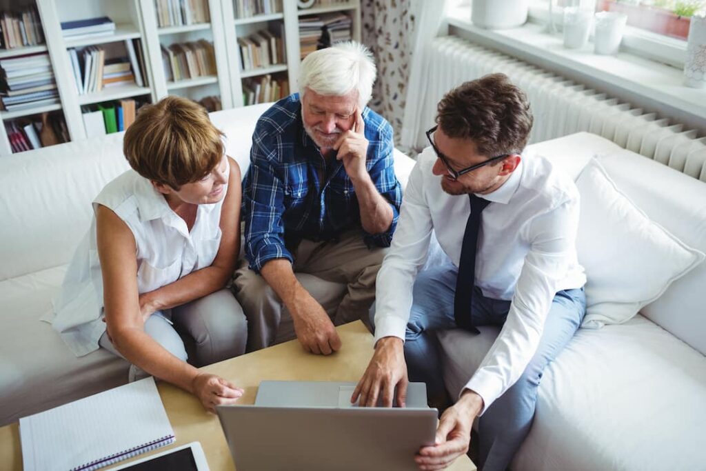 a realtor meets with senior couple to discuss their estate